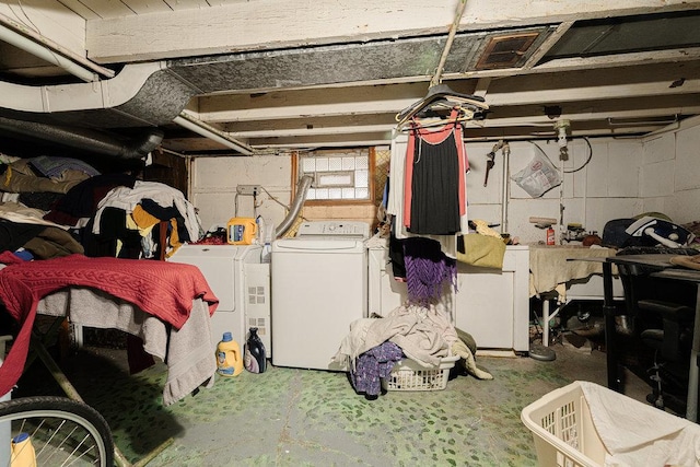 basement featuring fridge and washing machine and clothes dryer