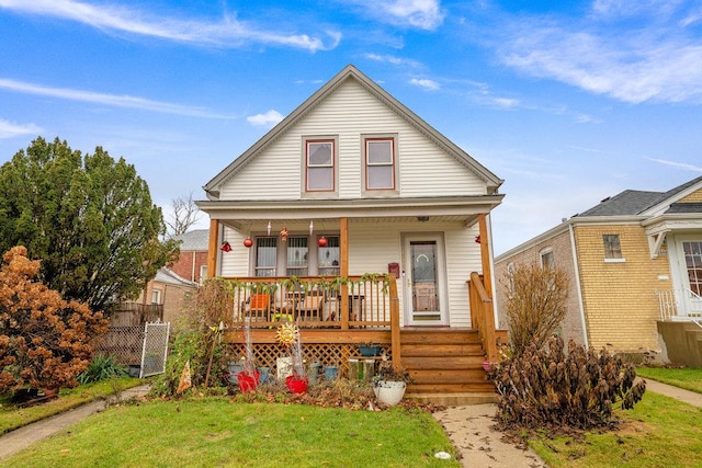 view of front facade featuring covered porch and a front yard