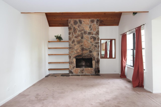 unfurnished living room featuring a fireplace, light carpet, and vaulted ceiling with beams