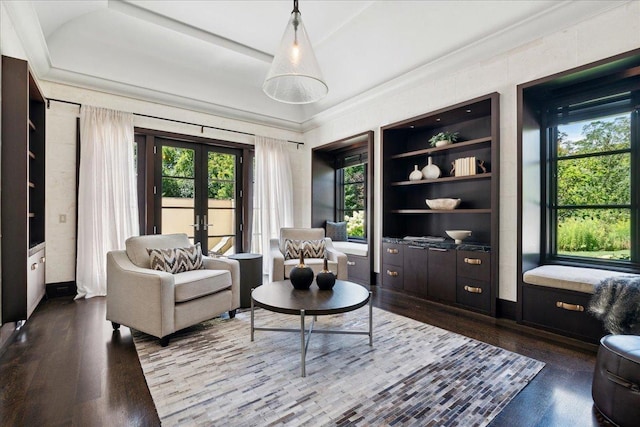 living room featuring french doors, hardwood / wood-style flooring, and built in features