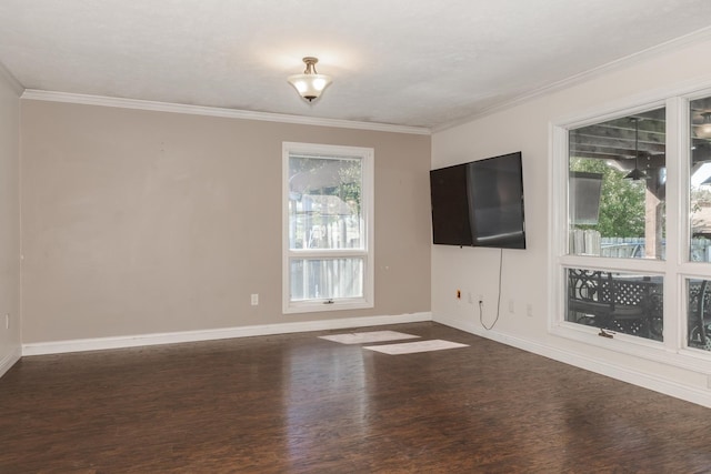 unfurnished room with dark hardwood / wood-style floors, ornamental molding, and a wealth of natural light