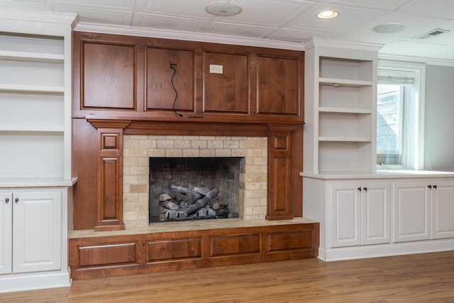 unfurnished living room featuring light wood-type flooring and built in features