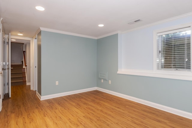 spare room with light hardwood / wood-style floors and ornamental molding