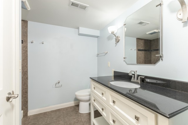 bathroom with tile patterned floors, vanity, and toilet