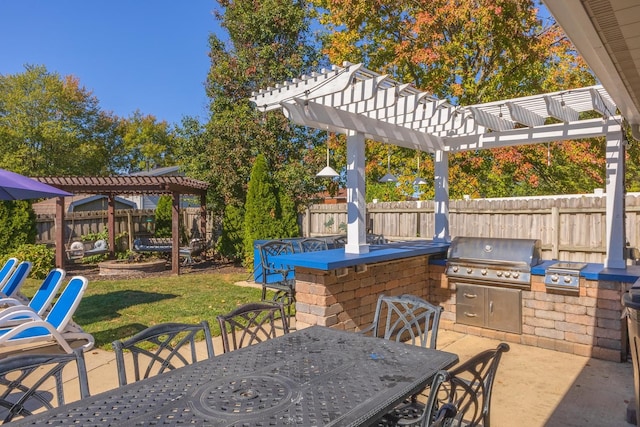 view of patio with a pergola, grilling area, exterior bar, and an outdoor kitchen