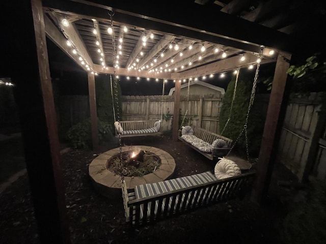 patio at twilight featuring a pergola and an outdoor fire pit