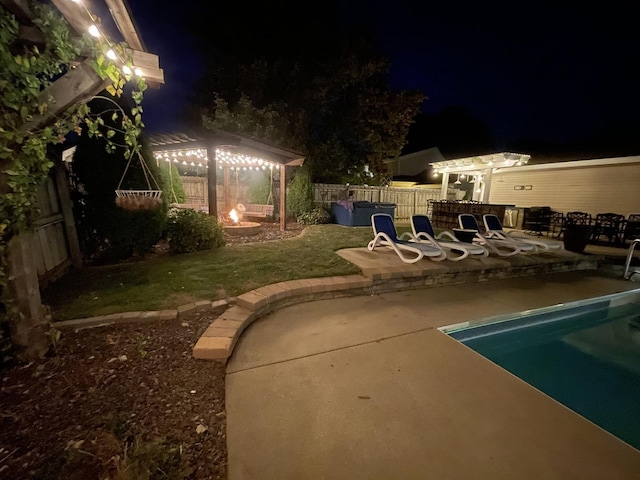 pool at twilight featuring an outdoor fire pit and a patio area