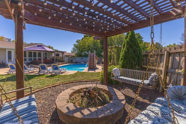 view of patio with a pergola, a fenced in pool, and an outdoor fire pit