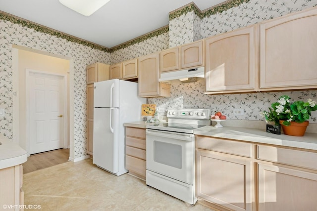 kitchen featuring light brown cabinetry and white appliances