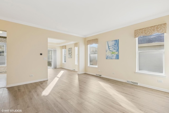 unfurnished room featuring crown molding and light wood-type flooring