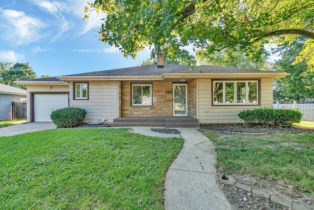 single story home featuring a front lawn and a garage