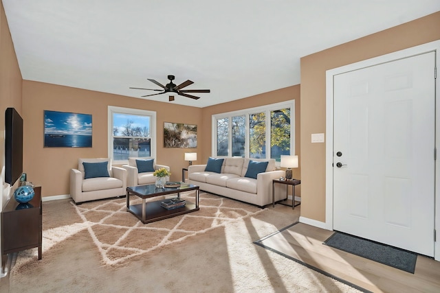 living room featuring ceiling fan and light carpet