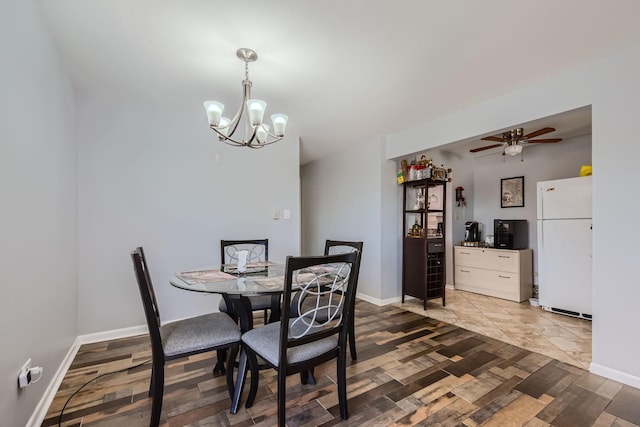 dining area featuring ceiling fan with notable chandelier