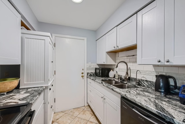 kitchen featuring white cabinets, light stone countertops, and sink