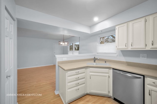 kitchen with white cabinetry, dishwasher, sink, hanging light fixtures, and light wood-type flooring