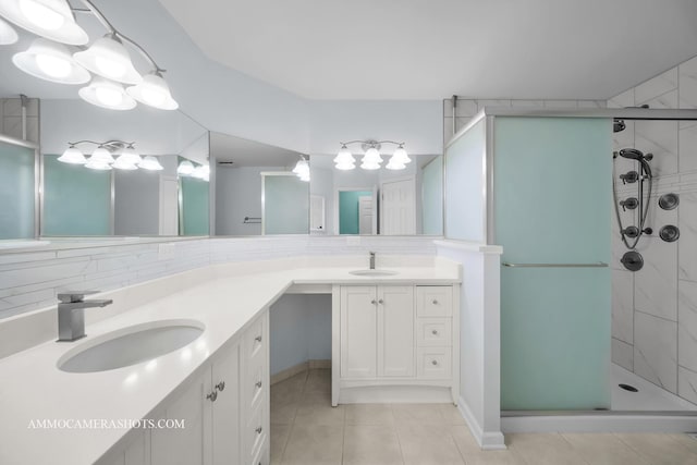 bathroom with vanity, backsplash, a shower with door, and tile patterned flooring