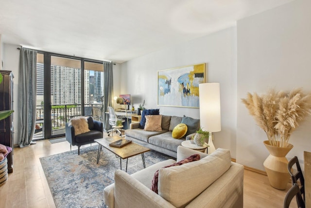 living room featuring floor to ceiling windows and light hardwood / wood-style floors