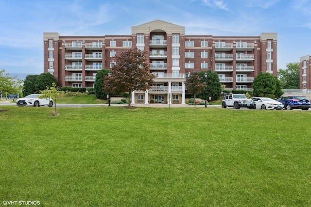 7041 W Touhy Ave Unit 209, Niles, IL 60714 - view of apartment building / complex featuring uncovered parking