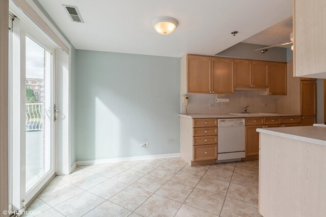 7041 W Touhy Ave Unit 209, Niles, IL 60714 - kitchen featuring dishwasher, plenty of natural light, light countertops, and backsplash