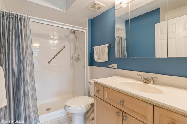 7041 W Touhy Ave Unit 209, Niles, IL 60714 - full bath with a shower stall, toilet, vanity, tile patterned floors, and a wainscoted wall