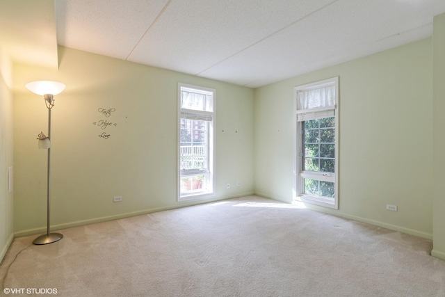 7041 W Touhy Ave Unit 209, Niles, IL 60714 - carpeted empty room with plenty of natural light and baseboards