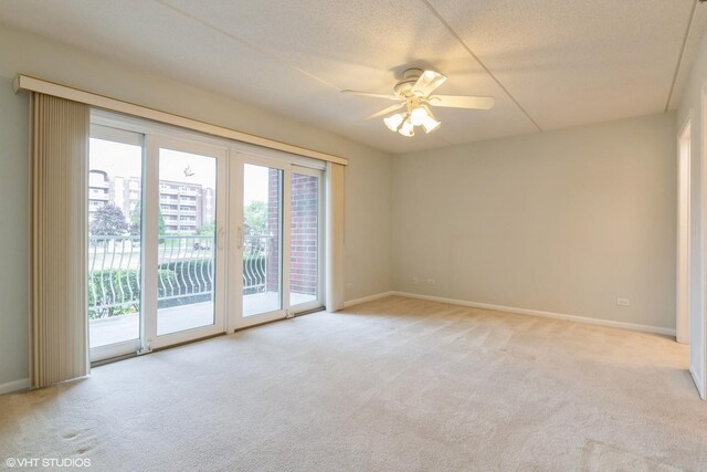 7041 W Touhy Ave Unit 209, Niles, IL 60714 - spare room with light colored carpet, a ceiling fan, and baseboards