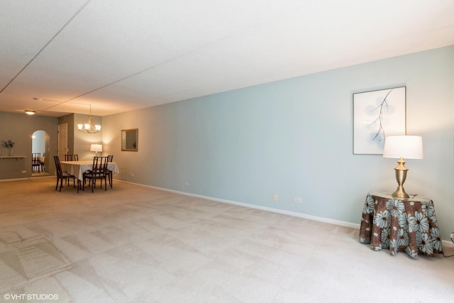 7041 W Touhy Ave Unit 209, Niles, IL 60714 - dining area with carpet, a chandelier, arched walkways, and baseboards