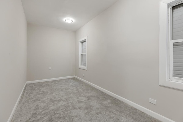 unfurnished room featuring light carpet