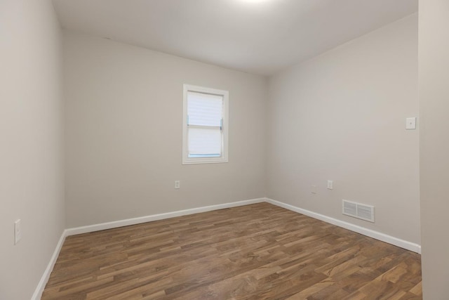 unfurnished room featuring dark hardwood / wood-style flooring