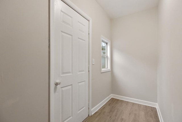 corridor with light hardwood / wood-style floors