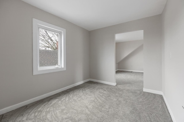 spare room featuring light colored carpet