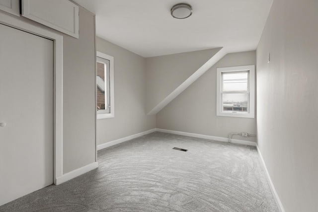 bonus room featuring carpet flooring and vaulted ceiling