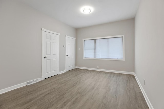 spare room with hardwood / wood-style floors