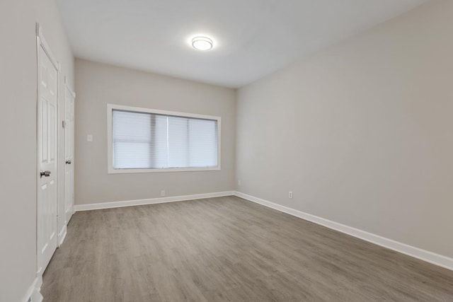 spare room with hardwood / wood-style floors