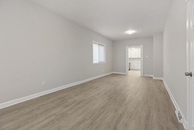 empty room with light hardwood / wood-style flooring