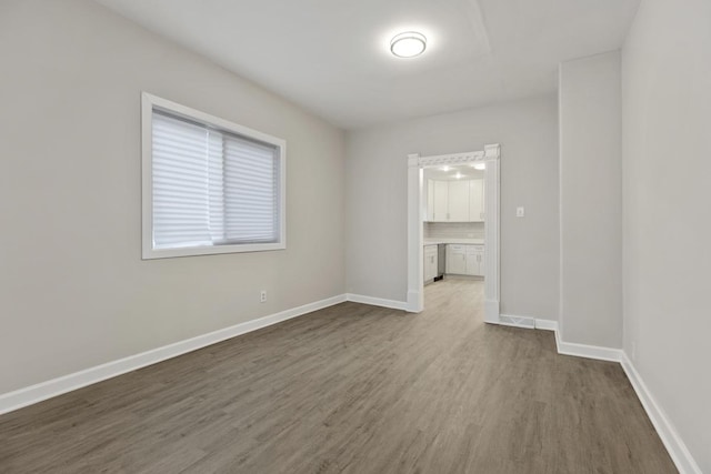 empty room with hardwood / wood-style floors