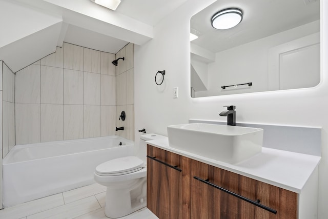 full bathroom featuring tiled shower / bath, tile patterned floors, vanity, and toilet