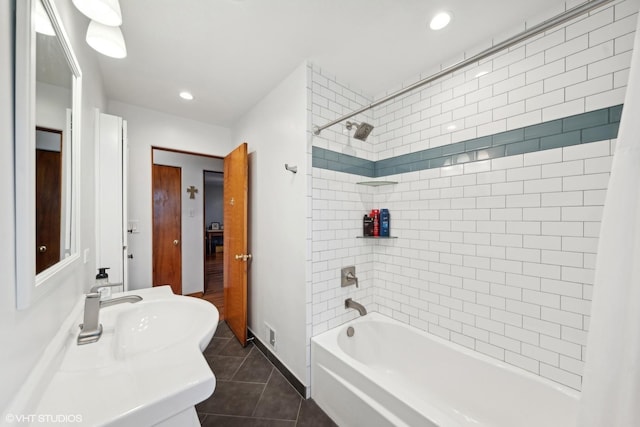 bathroom with tile patterned flooring, shower / tub combo with curtain, and sink