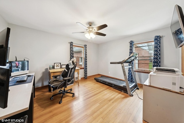 home office featuring wood-type flooring, plenty of natural light, and ceiling fan