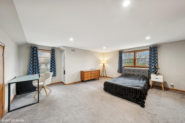 bedroom with lofted ceiling, carpet floors, and multiple windows