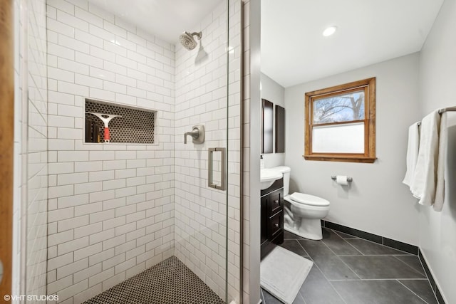 bathroom featuring tile patterned floors, vanity, an enclosed shower, and toilet