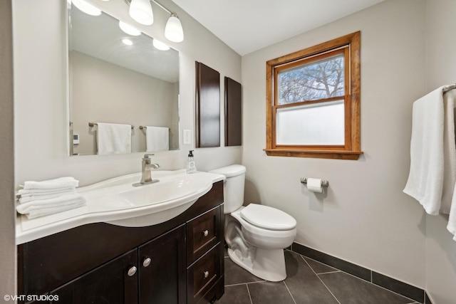 bathroom with tile patterned floors, vanity, and toilet