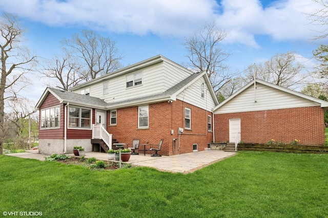 rear view of house with a lawn, a sunroom, and a patio