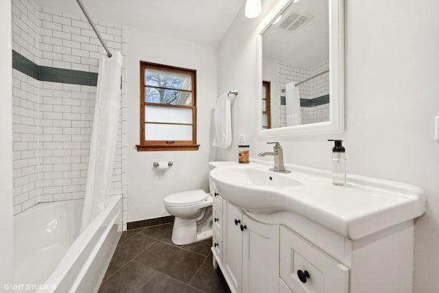 full bathroom featuring tile patterned floors, shower / bath combo with shower curtain, vanity, and toilet