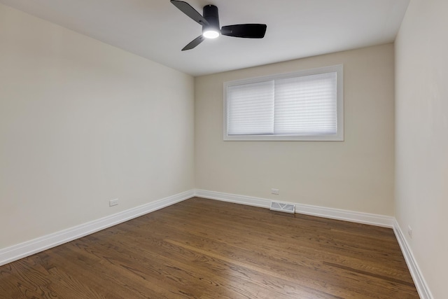 unfurnished room with ceiling fan and dark wood-type flooring