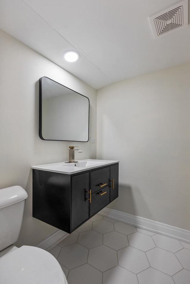 bathroom featuring tile patterned floors, vanity, and toilet