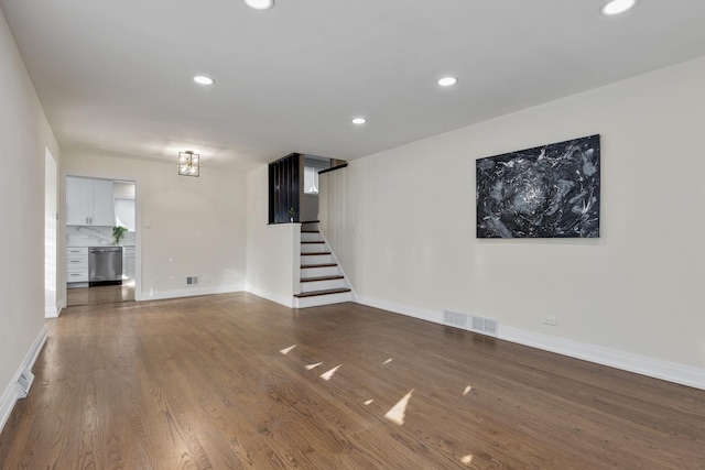 unfurnished living room with dark wood-type flooring