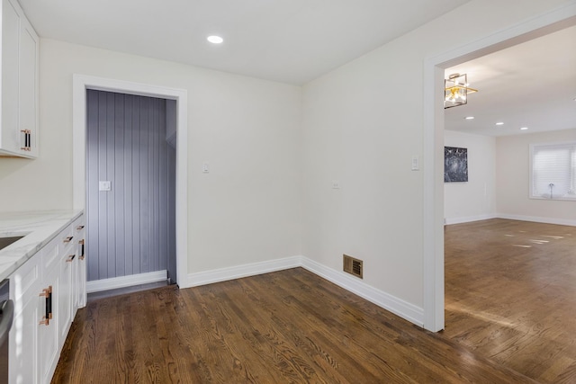 unfurnished dining area with dark hardwood / wood-style flooring