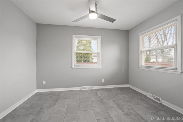 empty room with a wealth of natural light and ceiling fan