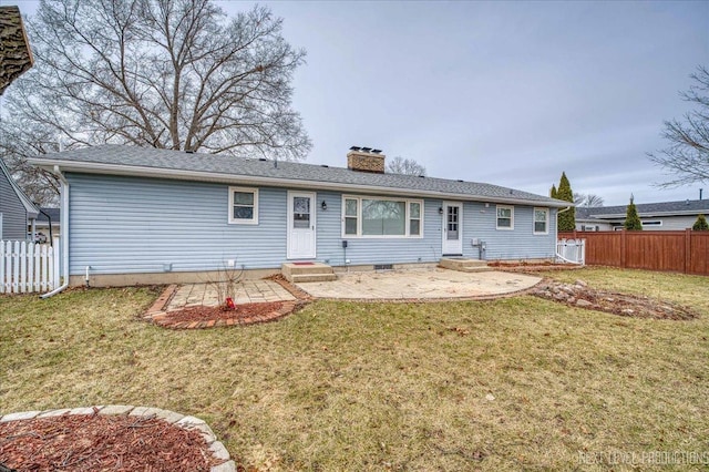 rear view of property with a lawn and a patio